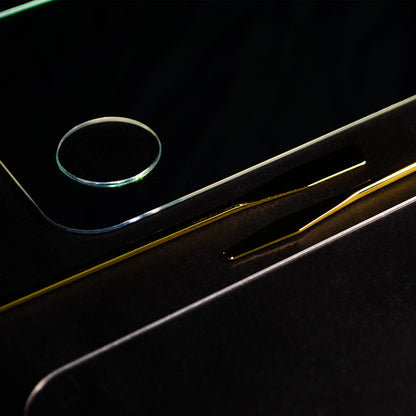 Close-up of the clear and holographic palettes stacked at an angle, showing the round thumb cutout and a gold spatula resting against the edges.