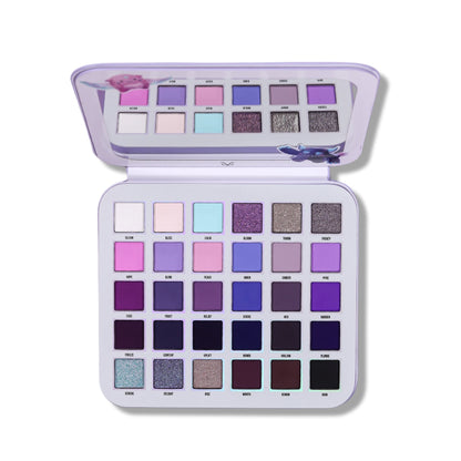 Gleam x Gloom palette open at an angle, lid mirror above a six by five grid of purple mattes and shimmers.