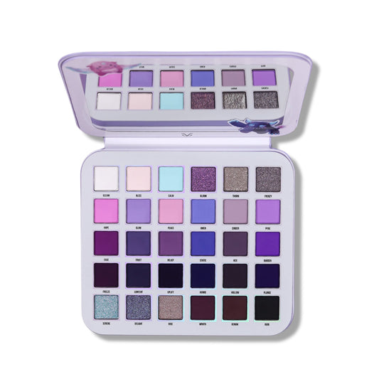 Gleam x Gloom palette open at an angle, lid mirror above a six by five grid of purple mattes and shimmers.