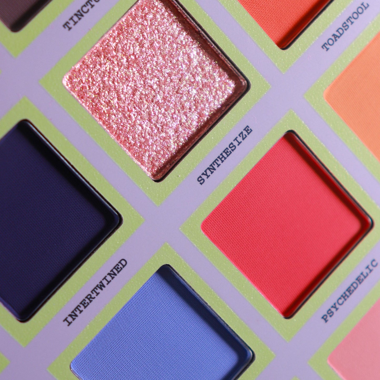 Close up of five Psilocybin pans, shimmering coral pink Synthesize, navy matte Intertwined, vivid red Psychedelic, and orange Toadstool