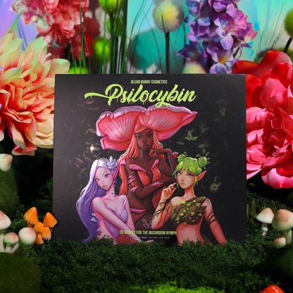 Psilocybin palette standing upright on moss surrounded by pink peonies and toy mushrooms, mushroom nymph cover art facing forward
