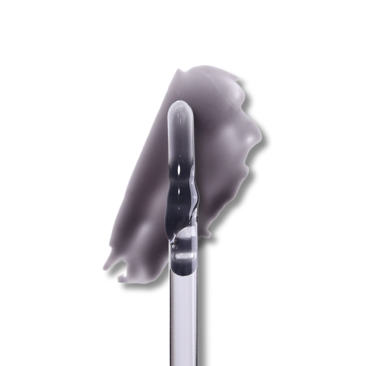 Spite lip milk swatch on white, a milky black gloss drawn out beside the doe-foot applicator.