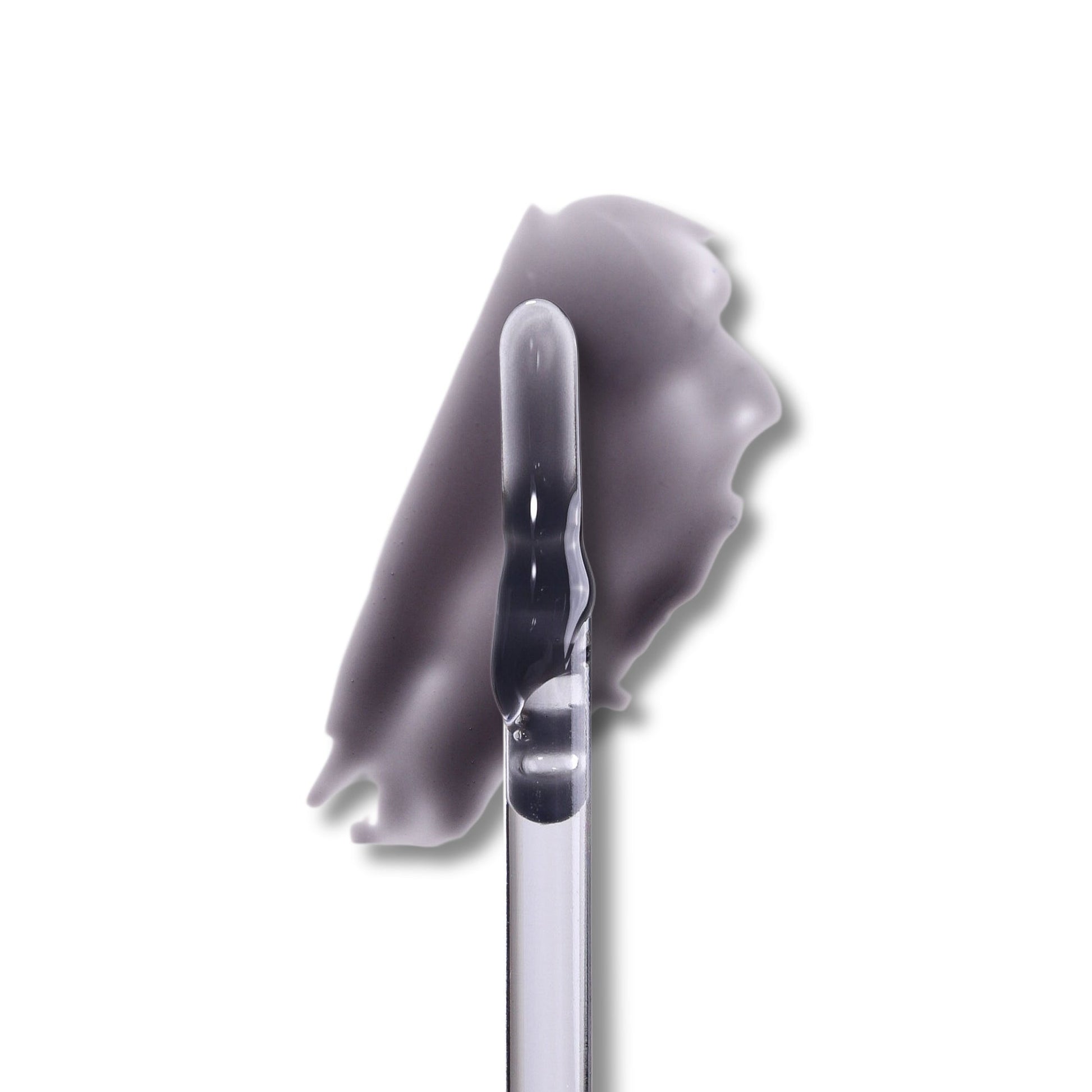 Spite lip milk swatch on white, a milky black gloss drawn out beside the doe-foot applicator.