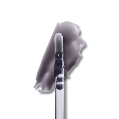 Spite lip milk swatch on white, a milky black gloss drawn out beside the doe-foot applicator.