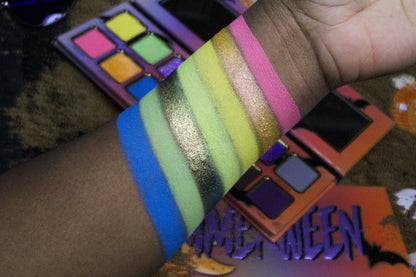 Blue, green, and gold shades from Summerween swatched on a deep skin tone, including a green-to-gold shifting sparkle and a hot pink