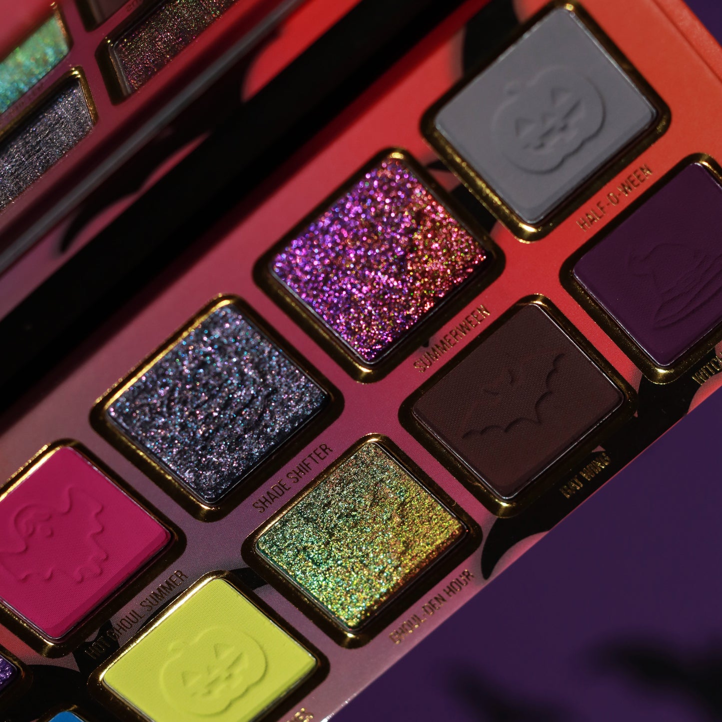 Close-up of Summerween pans including Shade Shifter, Summerween, Ghoul-Den Hour, Bat Wing, and Half-O-Ween, with bat and pumpkin motifs pressed in