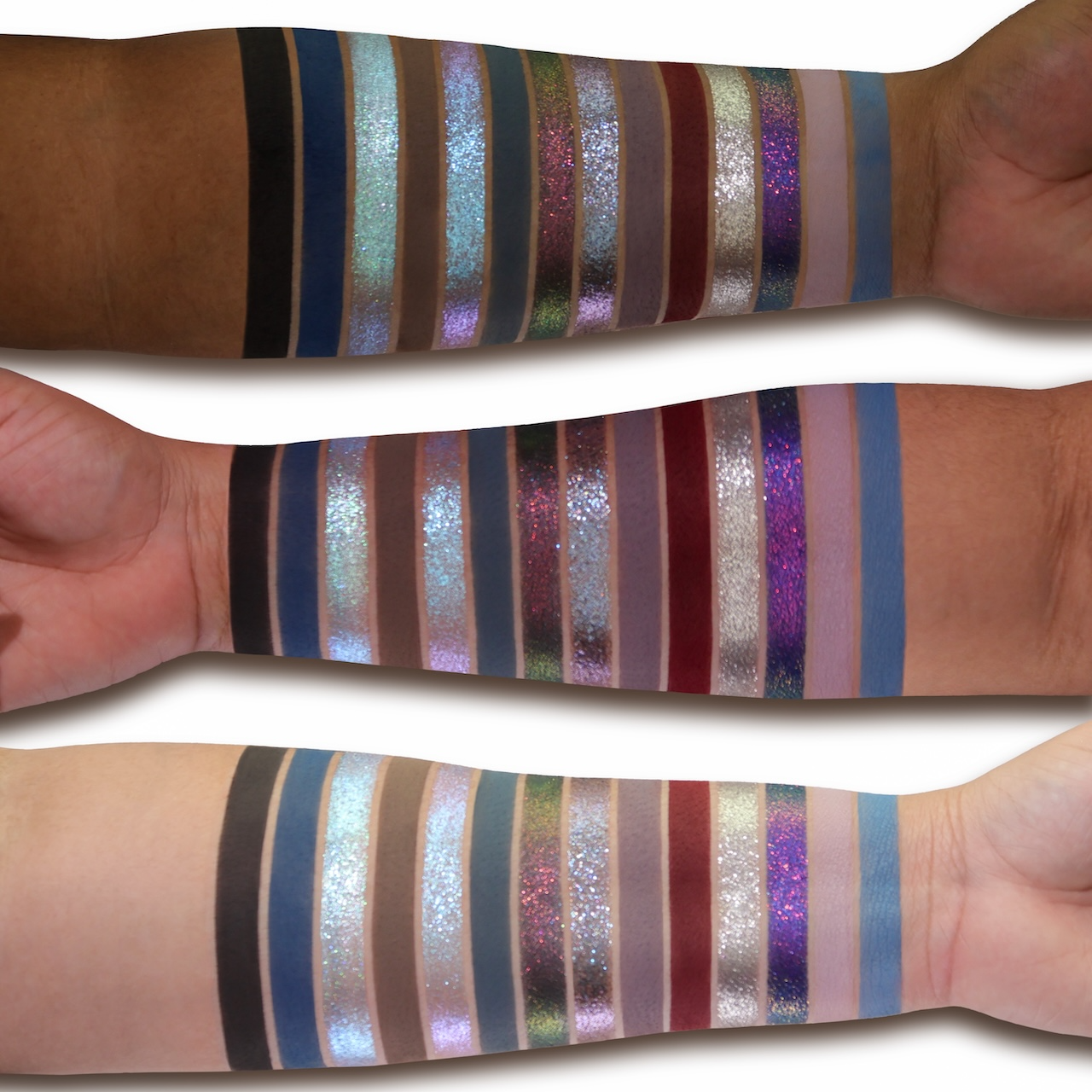 Thunderstruck swatches on three skin tones, the full range swiped side by side: black, navy, icy blues, mauves, a deep red, silver and violet sparkles