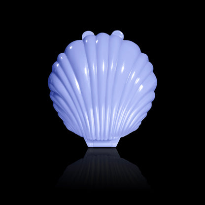 Dewlight glow closed in an iridescent periwinkle seashell compact