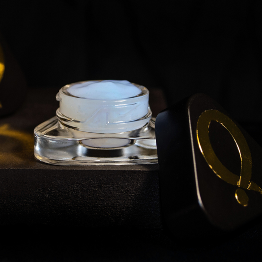 Question Beauty Gel Primer, open jar showing white gel formula with black lid and gold Q logo set against a dark background.