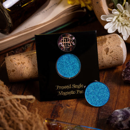 Wisteria Whisper on its pressed single magnetic pan card, with a loose pan, among dried herbs and bottles.