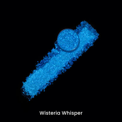 Wisteria Whisper pan on a smear of the bright blue pigment, on black.