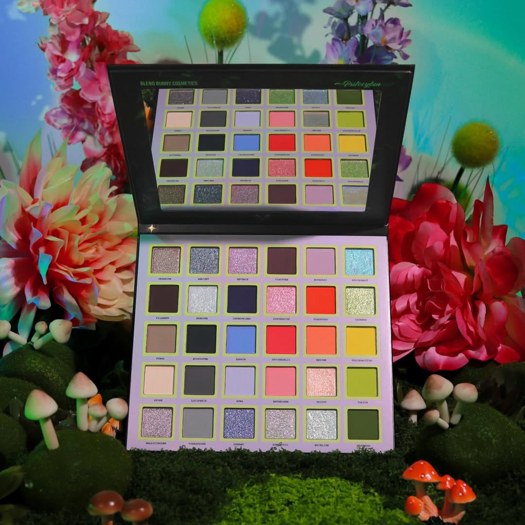 Blend Bunny Psilocybin eyeshadow palette open, 30 labeled shades from silvery sparkles through mushroom mattes into coral brights and forest greens