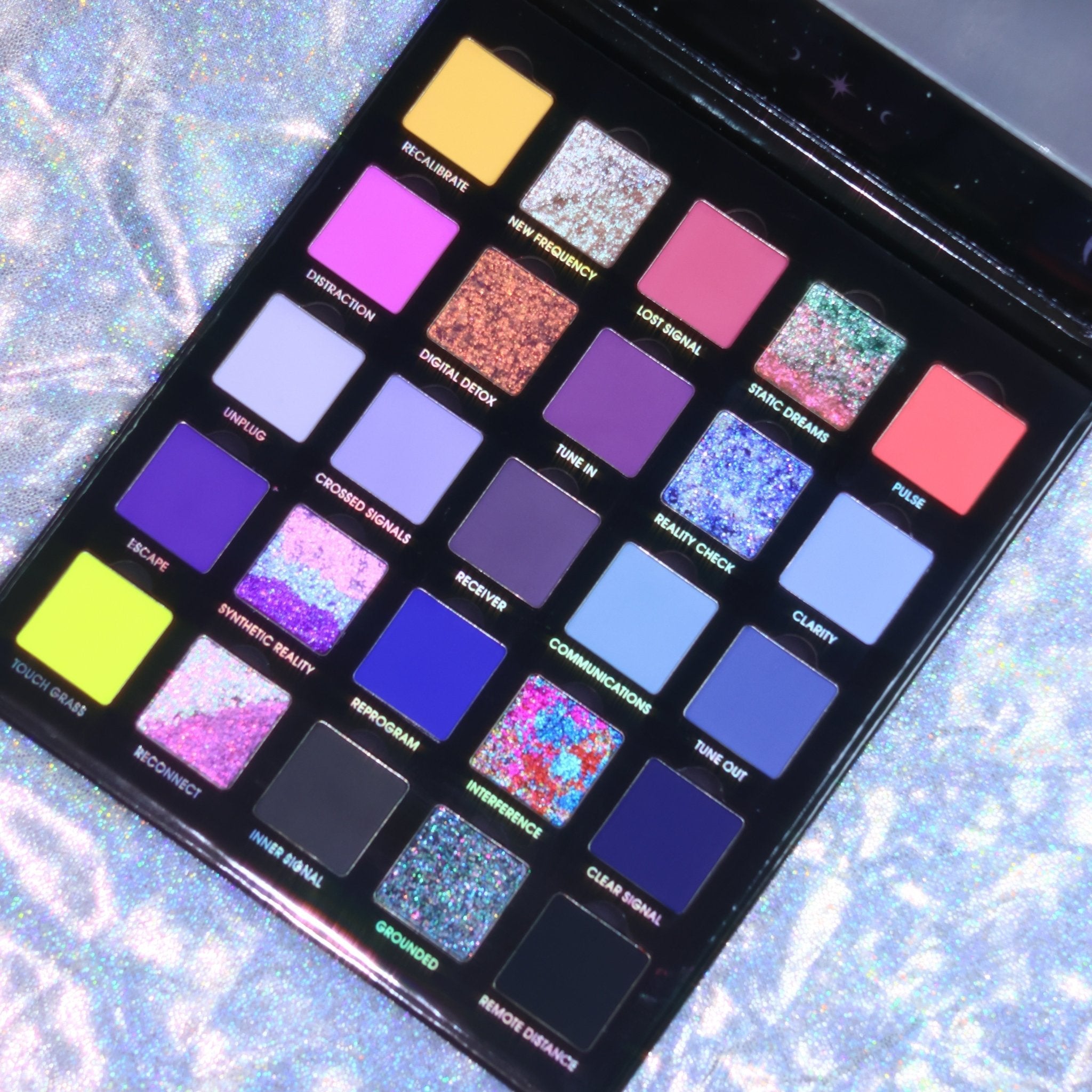 Change the Channel palette open on a holographic background, 25 labeled shades from neon yellow and pink through blues, purples, and sparkly multichromes