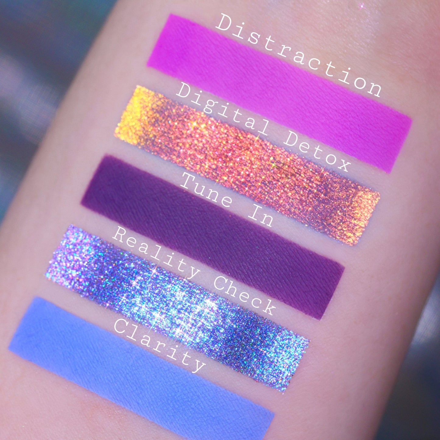 Swatches of Distraction, Digital Detox, Tune In, Reality Check, and Clarity, a magenta matte, peach-gold multichrome, plum, blue sparkle, and periwinkle