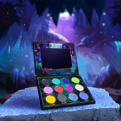Fantasy Cosmetica Cosmic Cove eyeshadow palette open, twelve shades in a magical underwater cave scene with purple jellyfish and crystals
