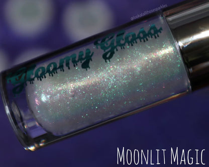 Moonlit Magic tube close-up on a purple backdrop, captioned with the shade name