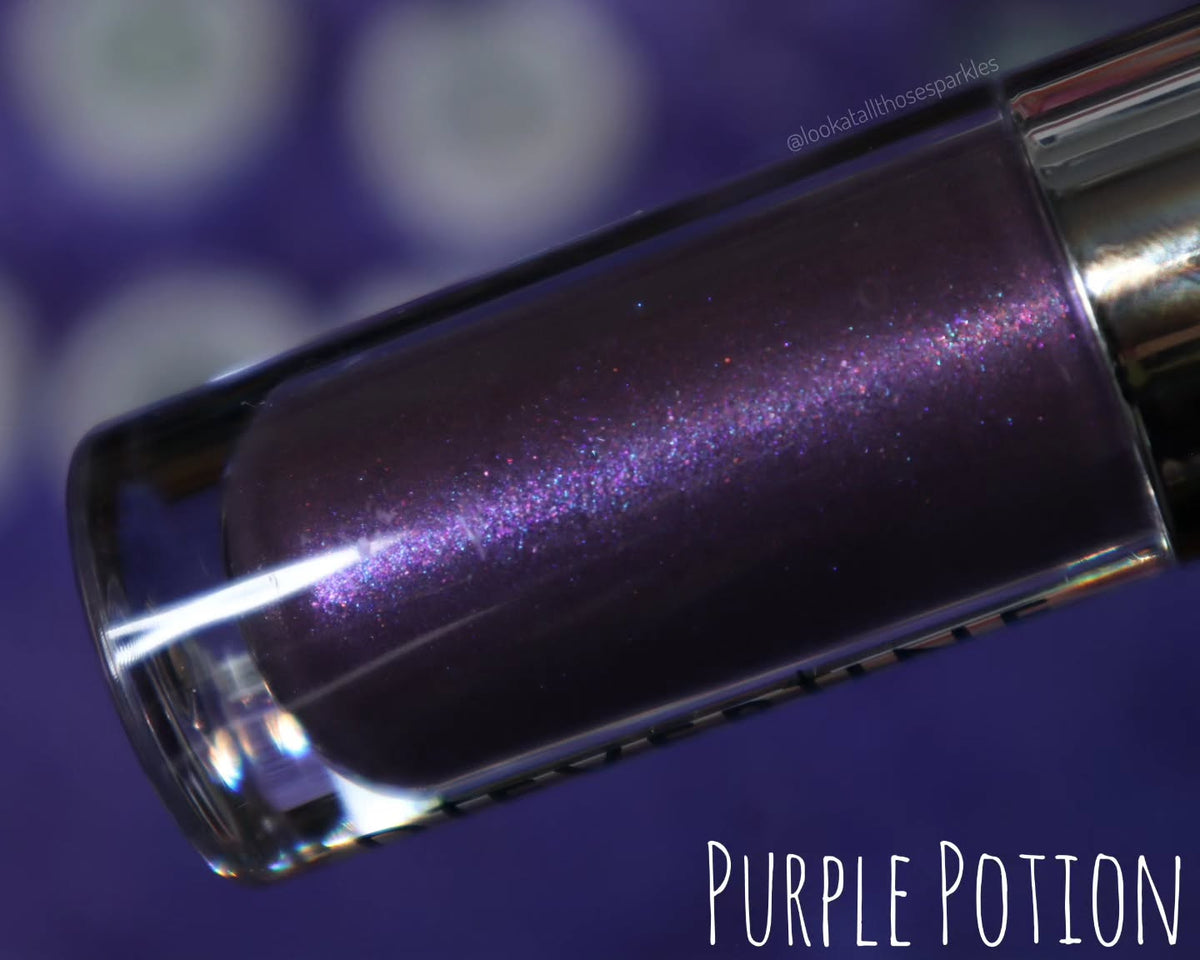 Purple Potion tube close-up on a purple backdrop, blue-violet shimmer in the purple base