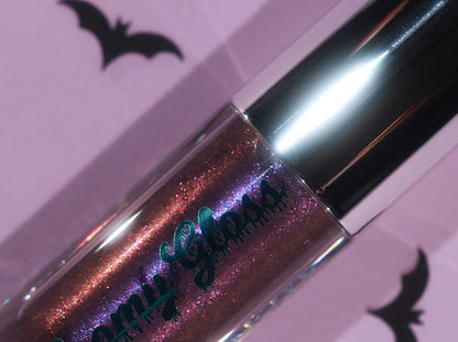 Purple Potion tube on a lilac backdrop with paper bats, purple and blue shimmer in a semi-sheer base