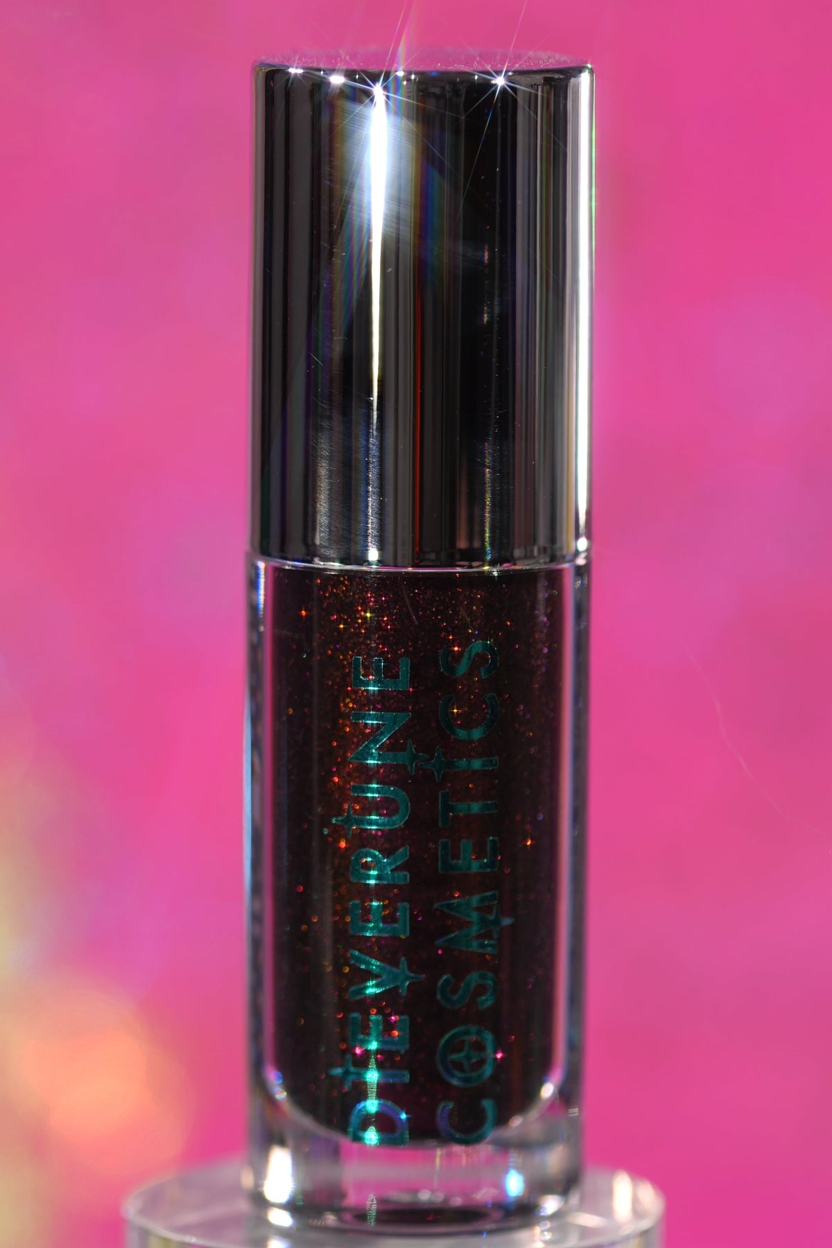Seance Shimmer tube standing upright on a pink backdrop, logo side facing out