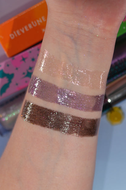 Wrist swatches of the three glosses, clear, mauve and deep brown, with Dieverune boxes behind