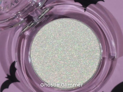 Ghostie Glimmer open compact on a lilac backdrop with black bat cut-outs