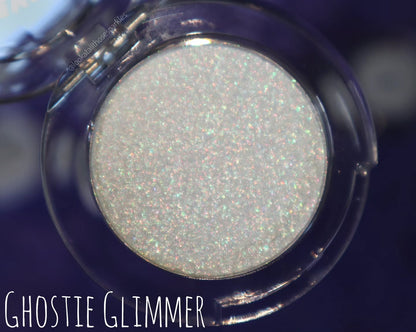 Ghostie Glimmer open compact on a navy background, brand label lower left