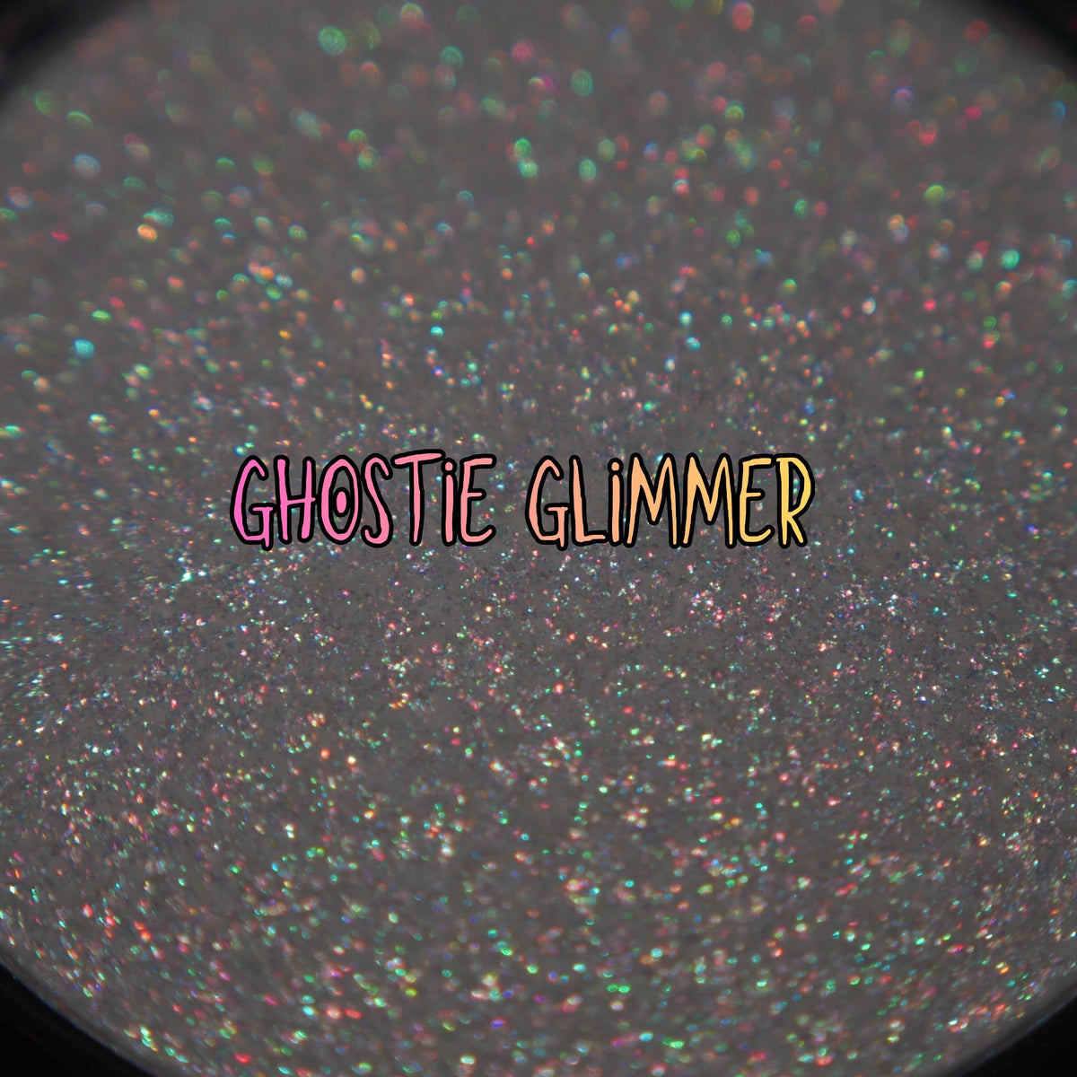 Ghostie Glimmer pan macro with the brand label, green, orange, pink and purple sparkle points