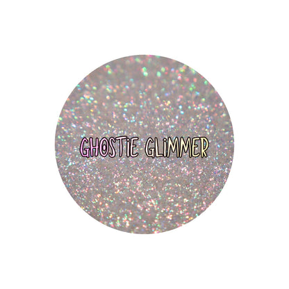 Dieverune Cosmetics Sporkleween highlighter in Ghostie Glimmer, round pan close-up labelled by the brand, multicoloured sparkles on a transparent base