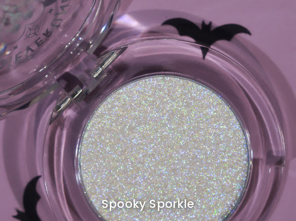Spooky Sporkle open compact on a lilac backdrop with black bat cut-outs