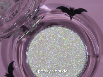 Spooky Sporkle open compact on a lilac backdrop with black bat cut-outs