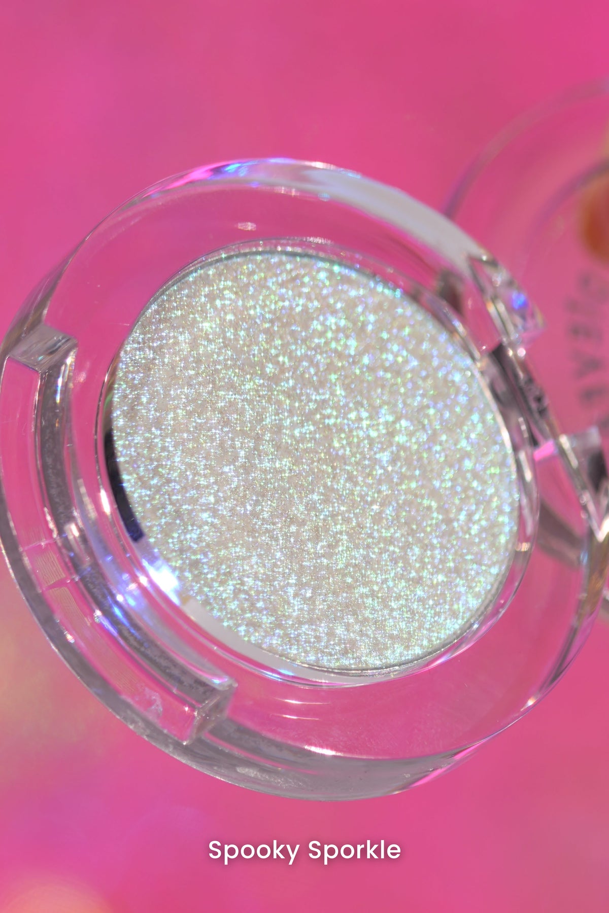 Spooky Sporkle open clear compact angled against a pink backdrop