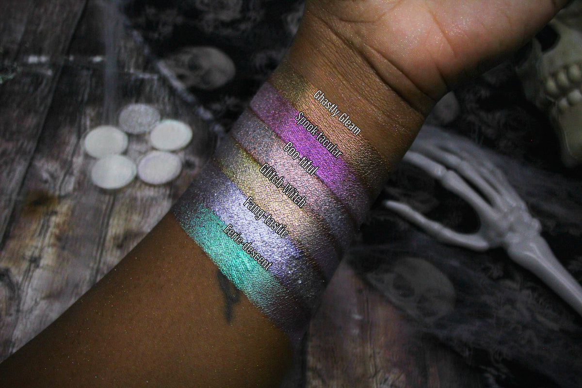All six Sporkleween singles swatched on deep skin beside loose pans and a skeleton hand, labelled