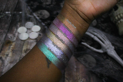 All six Sporkleween singles swatched on deep skin beside loose pans and a skeleton hand, labelled