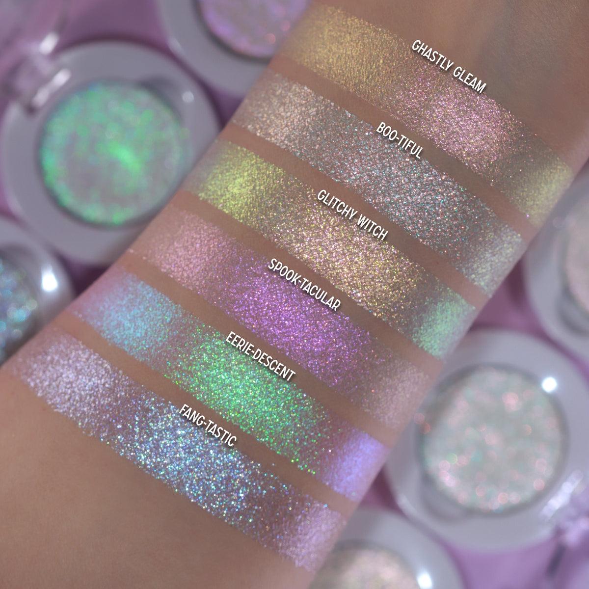 All six Sporkleween singles swatched on light skin among open compacts, labelled, Ghastly Gleam at the top