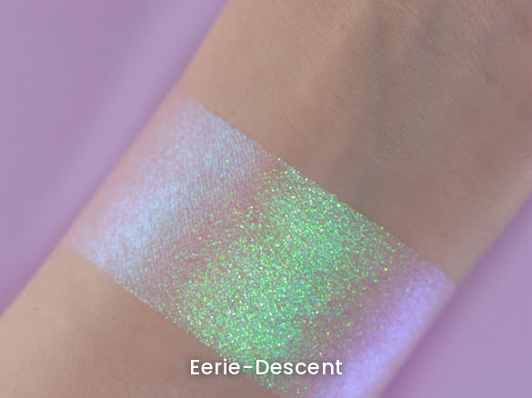 Eerie-Descent swatch on light skin against a lilac backdrop