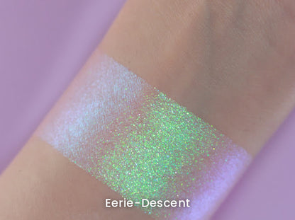 Eerie-Descent swatch on light skin against a lilac backdrop