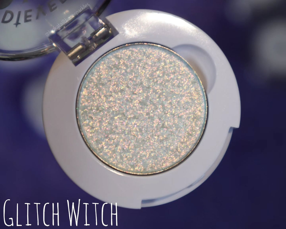 Glitch Witch in its open compact on a blue backdrop, labelled