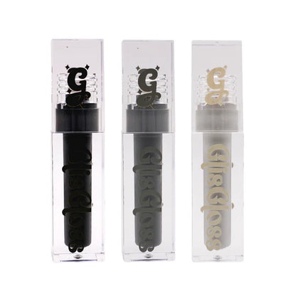 Glis Gloss by Glisten Cosmetics: three clear acrylic tubes lined up showing Liquorice black, Veil dark grey, and Grey Area light grey gloss