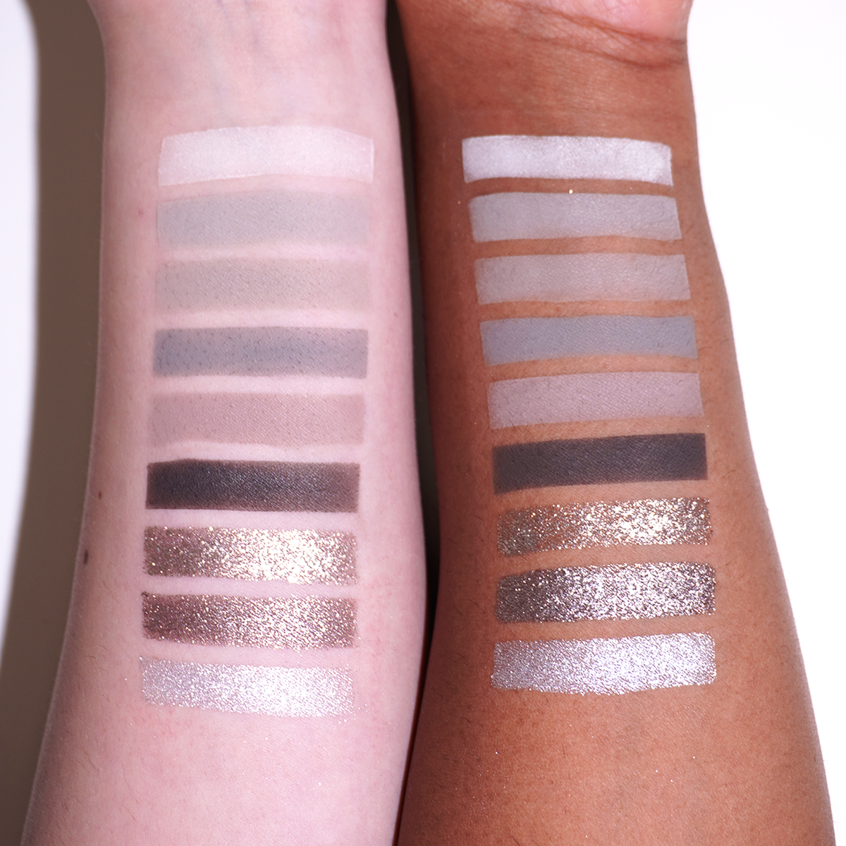 Bliss 2.0 arm swatches on light and deep skin: six mattes from off-white to charcoal, then three sparkles in taupe, mauve-grey and silver