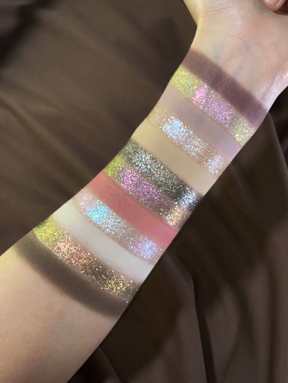 Pâtisserie arm swatches in warmer light over brown satin, the sparkle shades catching green, pink and icy blue