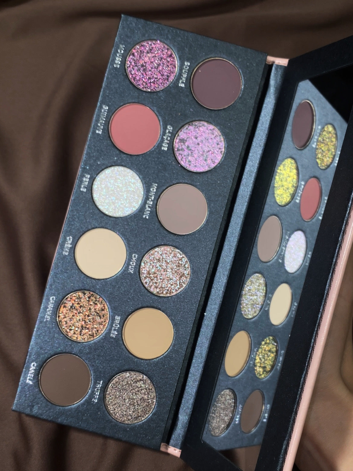 Close-up of the 12 Pâtisserie pans on brown satin, shade names printed beside each one