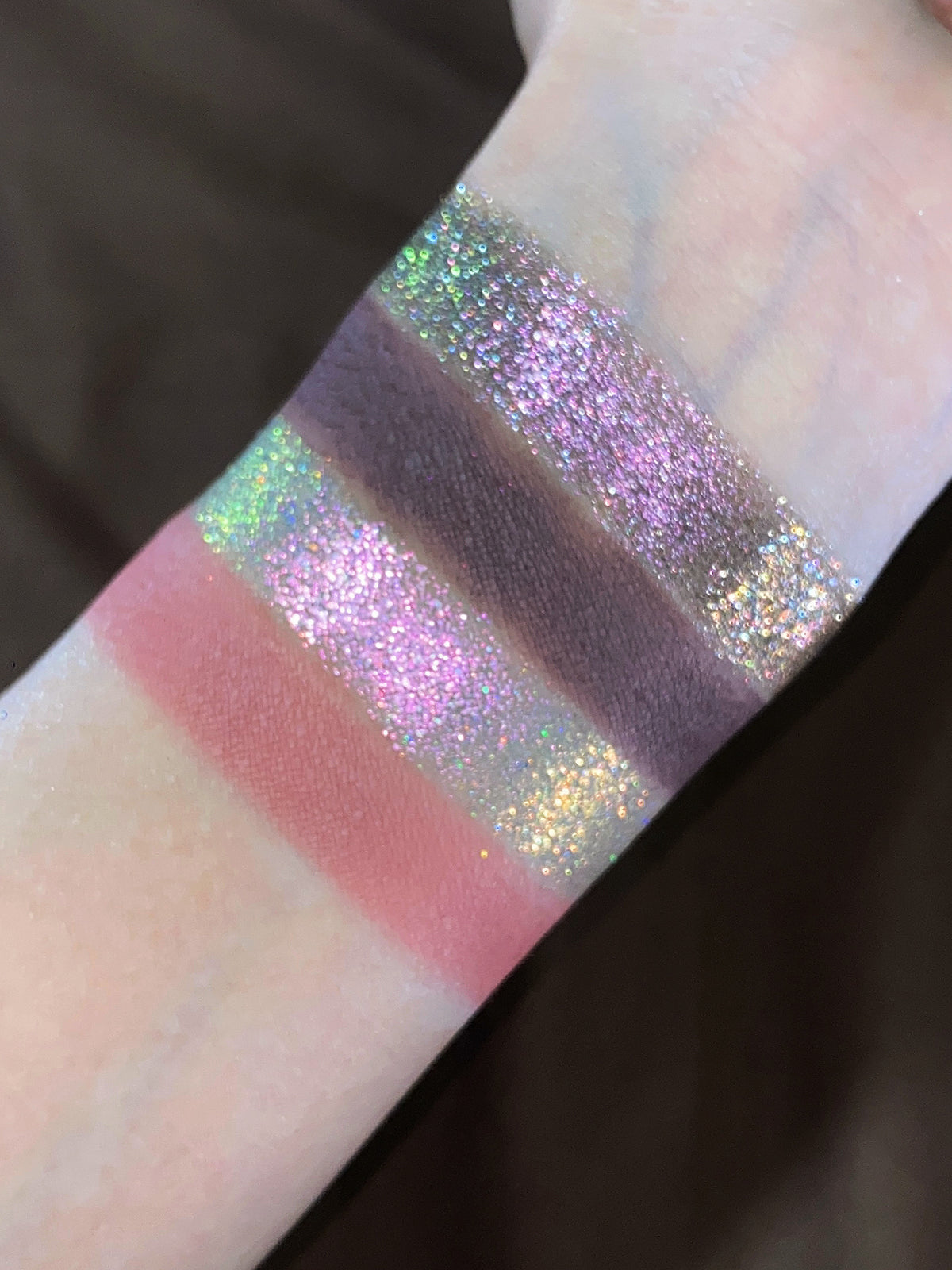 Close-up swatches: dusty rose and plum mattes between pink and green sparkle shades