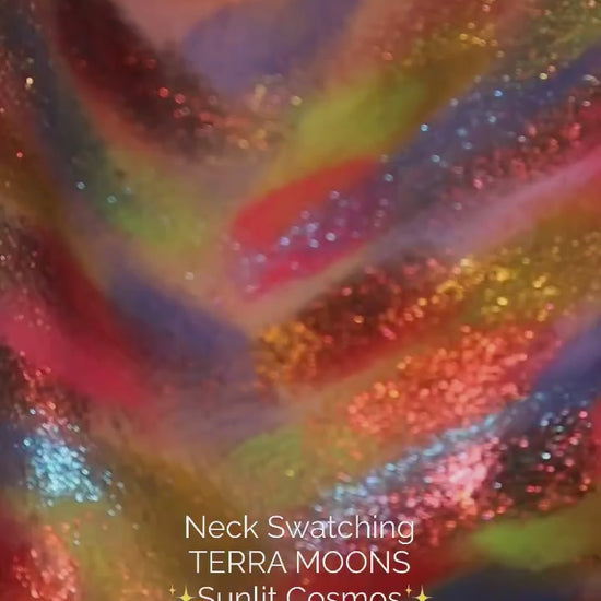 Neck swatch video of the Sunlit Cosmos palette, the full range brushed on in stripes of pink, yellow, blue, orange and red with sparkle shades layered over them