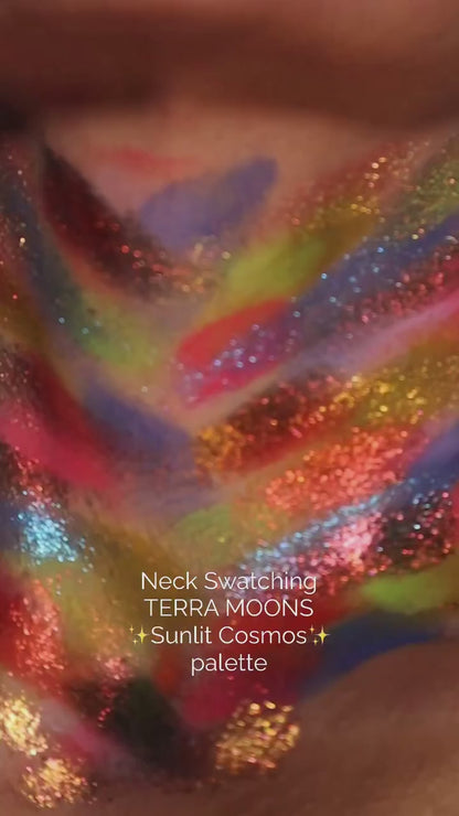Neck swatch video of the Sunlit Cosmos palette, the full range brushed on in stripes of pink, yellow, blue, orange and red with sparkle shades layered over them