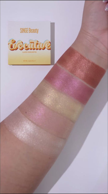 Video of all five highlighter shades swatched in a row on a forearm beside the yellow Evocative box