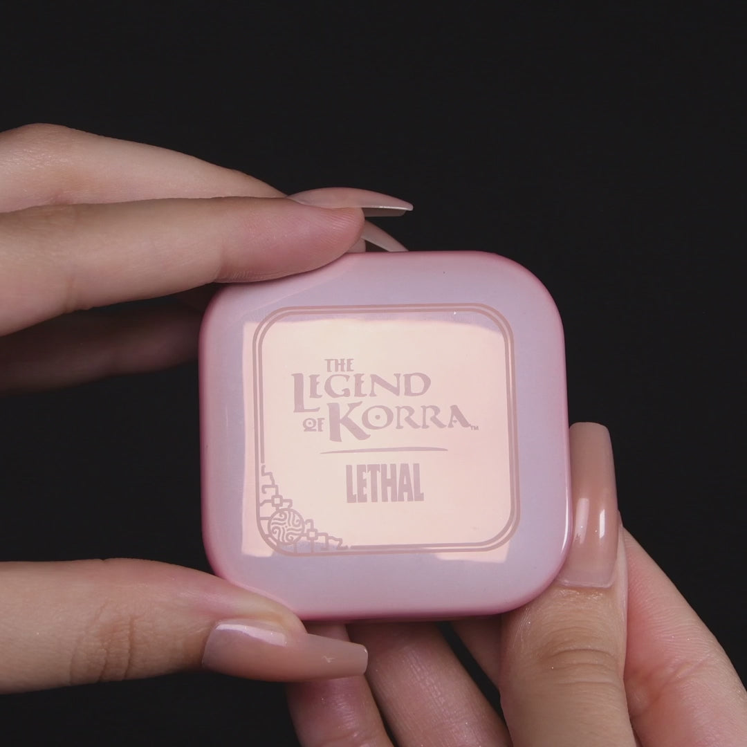 Video of the Naga blushlighter opened in hand, with a close-up of the embossed pan and arm swatches of the lilac and pearl white shades