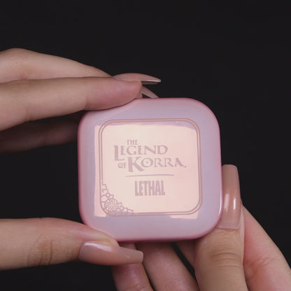 Video of the Naga blushlighter opened in hand, with a close-up of the embossed pan and arm swatches of the lilac and pearl white shades