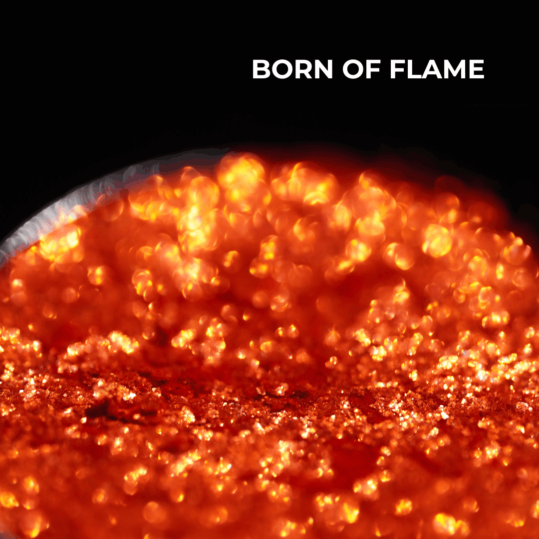 Born of Flame pan macro: orange and red shimmer with gold sparks, shade name in white type at the top.