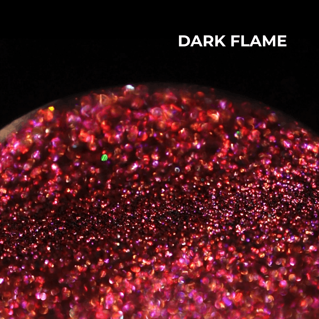 Dark Flame pan macro: deep red base scattered with pink and red sparkle, shade name in white type at the top.