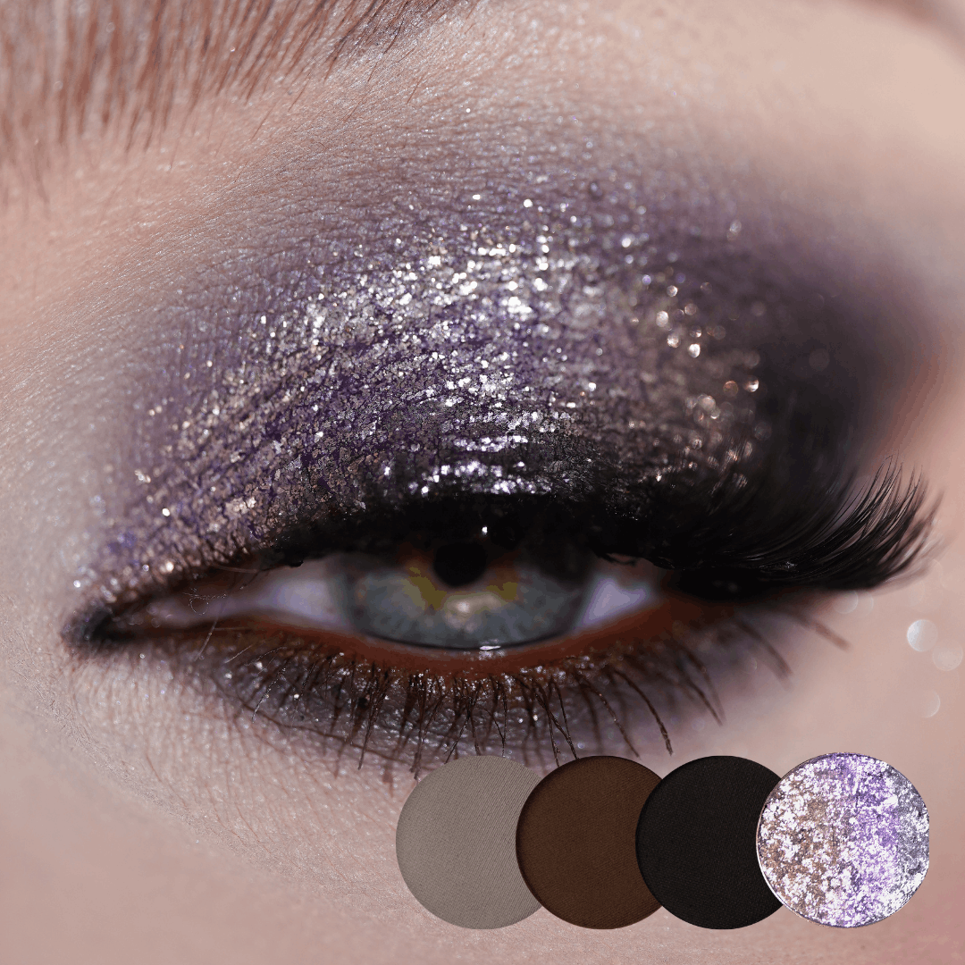 Close-up of an eye with silver-lilac sparkle on the lid and a black outer corner, grey, brown, black and silver shade dots below.